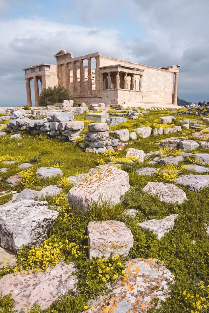 The Erechtheum in the background, with the ruins of the Old Temple of Athena in the foreground.