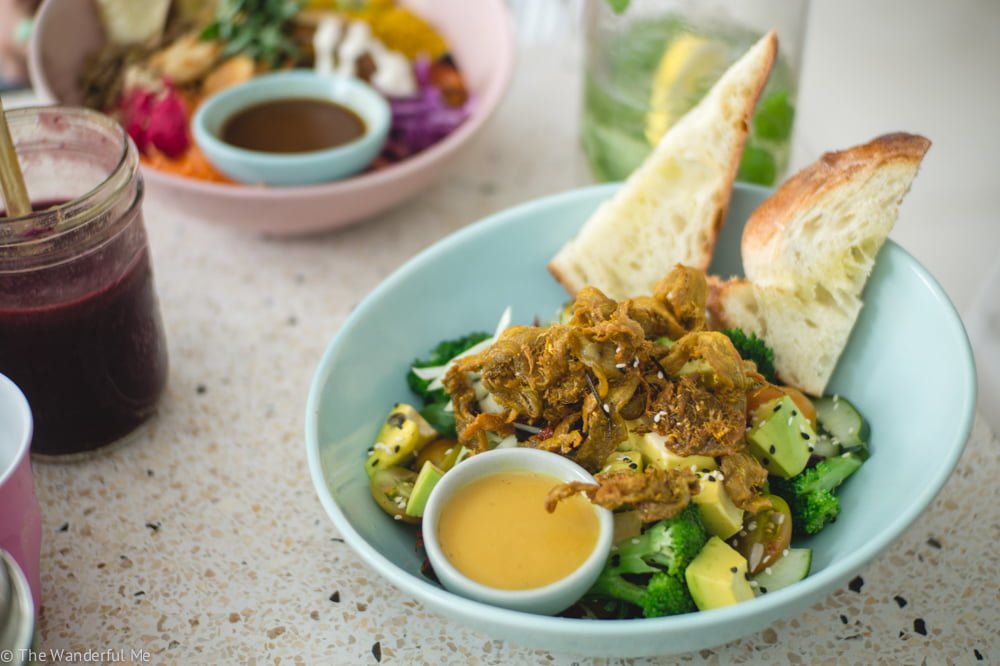 A gorgeous green salad with fried "chicken", sourdough bread, avocado, and a goddess dressing from the vegan restaurant Kynd Community in Canggu.