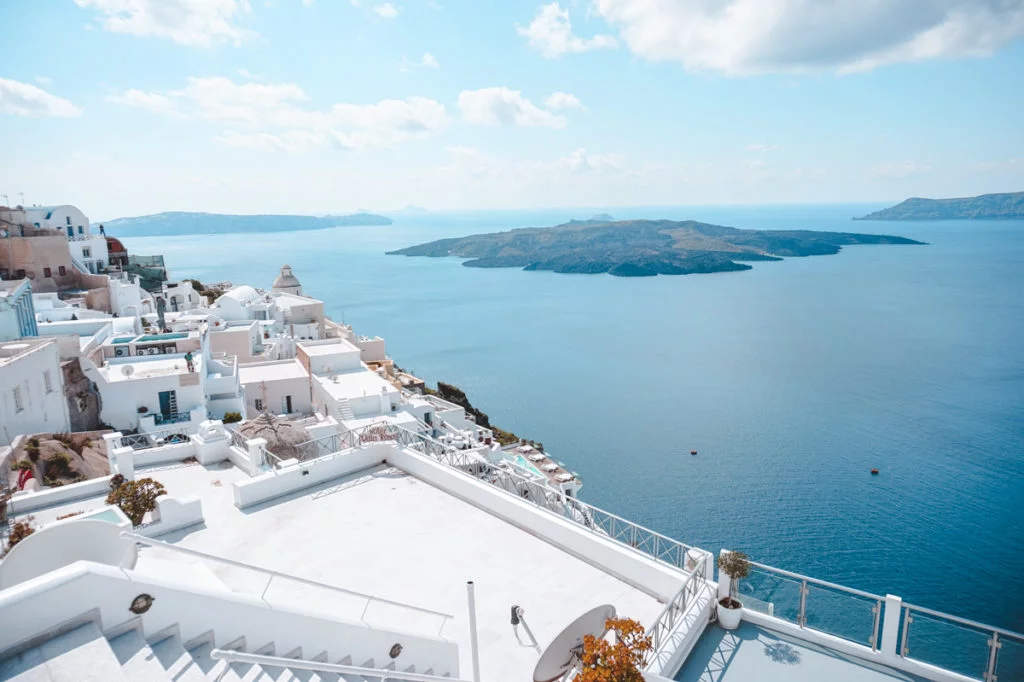 Stunning view overlooking the sea in front of Fira, a must-visit town when exploring Santorini island on your two-week Greek island hopping trip. 