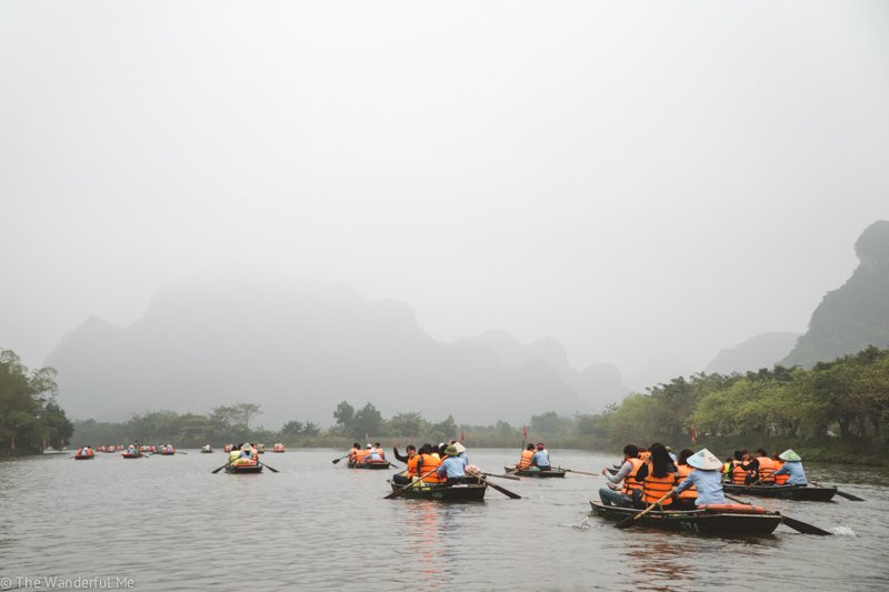 Hoards of tourists packed in boats along the river in Ninh Binh, Vietnam.