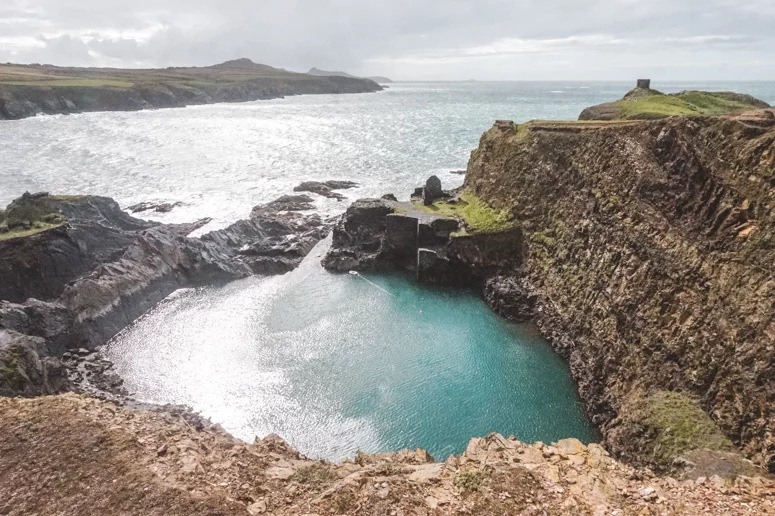 The Blue Lagoon with its turquoise waters and glistening sheen, located on the Pembrokeshire Coast in South Wales. 