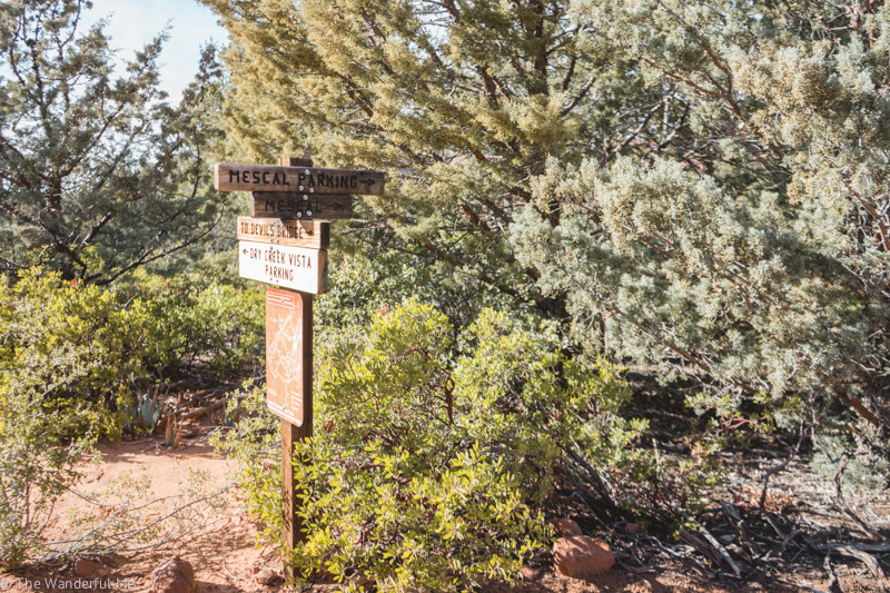 A trail marker stating which way Mescal Parking, Devil's Bridge, and Dry Creek Vista Parking is. 
