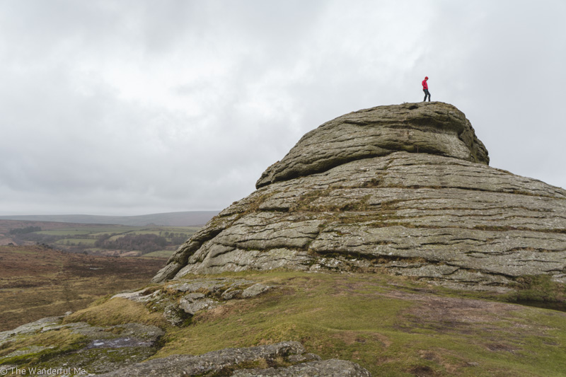 Dan, aka The Wanderful Husband, standing on Haytor Rocks in Dartmoor National Park, one of the most magical places to visit in England. 