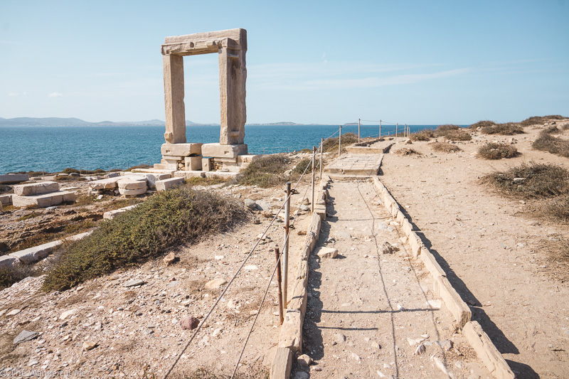 The Temple of Apollo and its Portara ruins standing tall on the island of Naxos in Greece, one of my favorite spots on my two-week Greek island hopping trip. 
